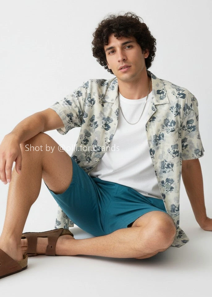 White Graphic Shirt and Blue Shorts men's wear lookbook image.