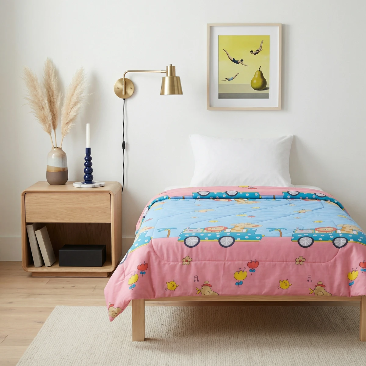Kanika comforter featuring colorful animal and car patterns in pink and blue on a wooden bed.