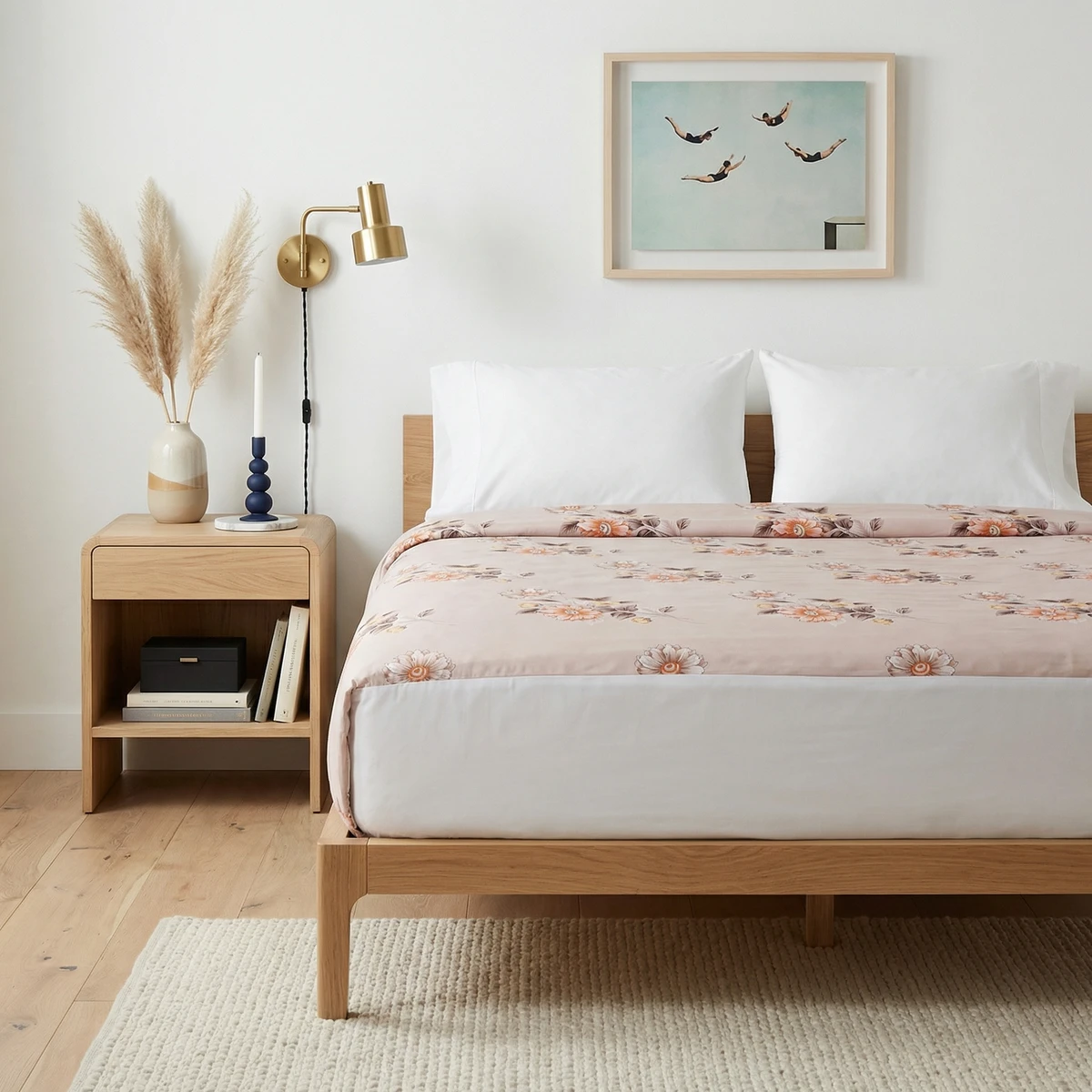 Kanika comforter featuring a muted pink floral print on a bed in a bright bedroom.