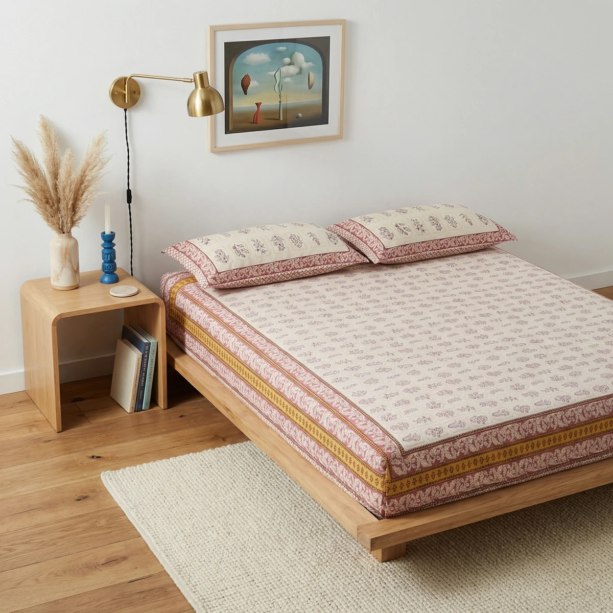 Voila bed sheets with pink floral print and matching pillows on wooden bed frame.