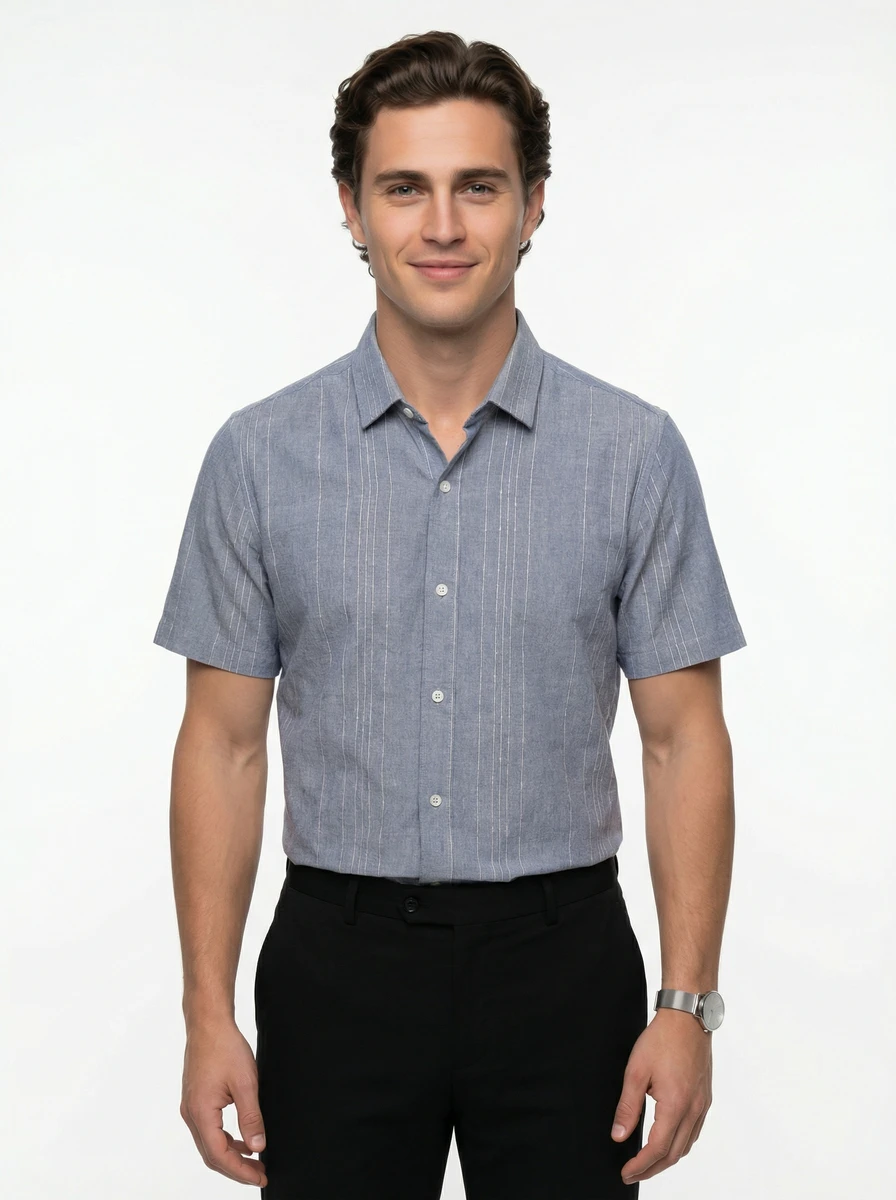 Male model wearing a short-sleeve blue striped button-down shirt and black trousers against a white background.