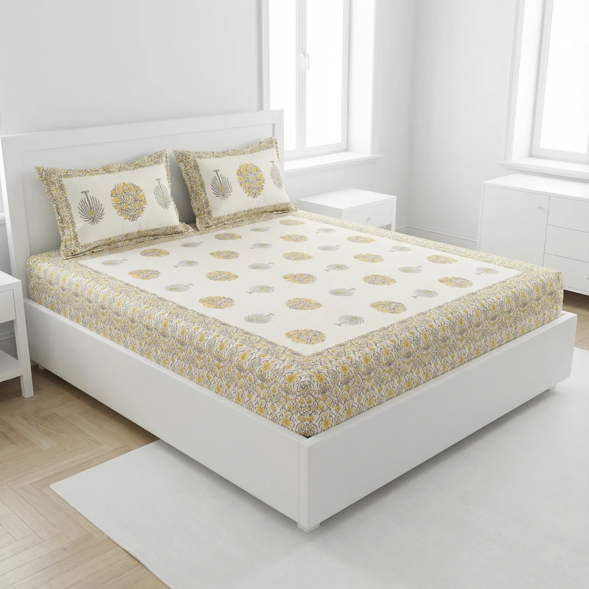 GARV bed sheets with yellow and grey floral block prints on a white bed in a bright minimalist bedroom.