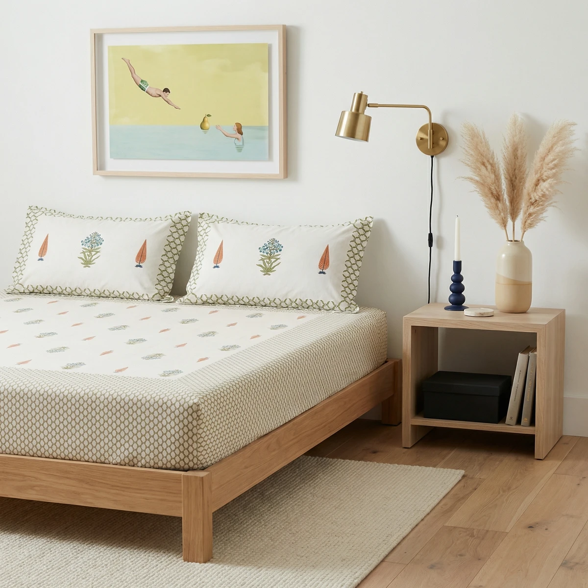 Kanika bed with white cotton bed sheets featuring floral block prints and matching pillows in a bright bedroom.