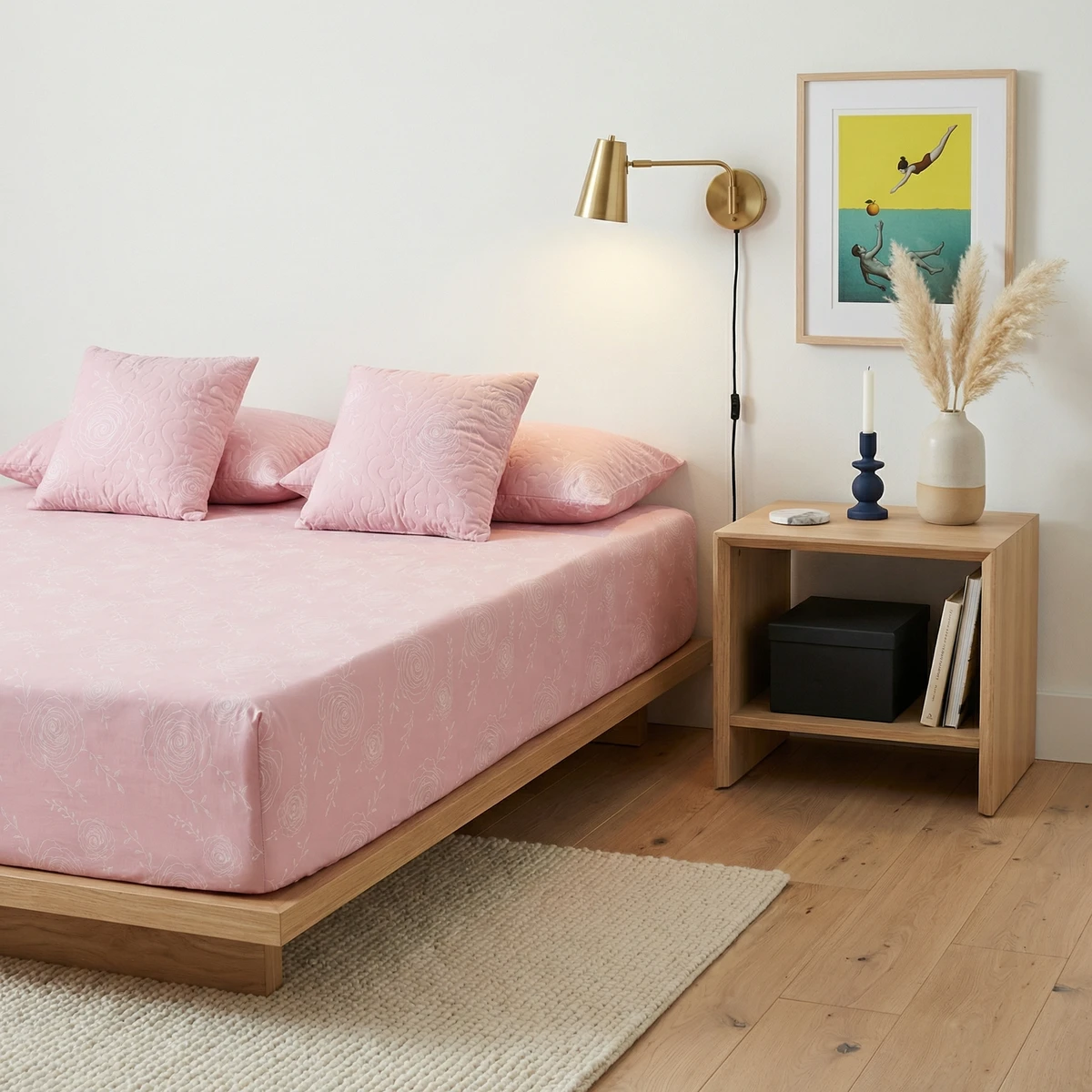 Kanika bed sheets featuring pink cotton fabric with a white floral line pattern, styled with matching pillows on a wooden frame.