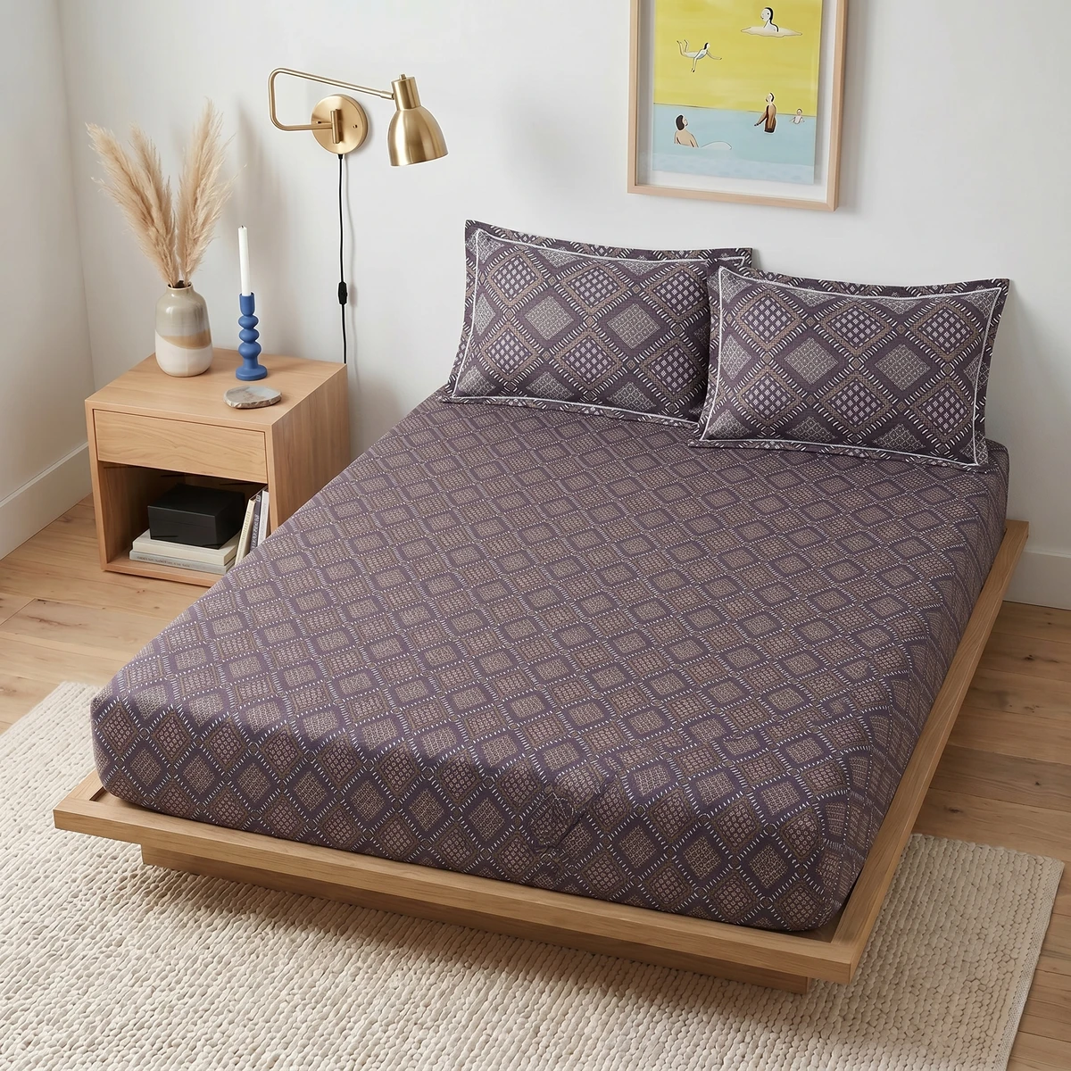Viveka bed dressed in purple patterned sheets with matching pillows in a modern bedroom.
