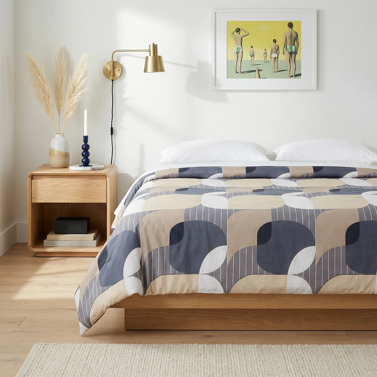 Kanika comforter featuring a geometric pattern in blue, beige, and white on a platform bed in a modern bedroom.