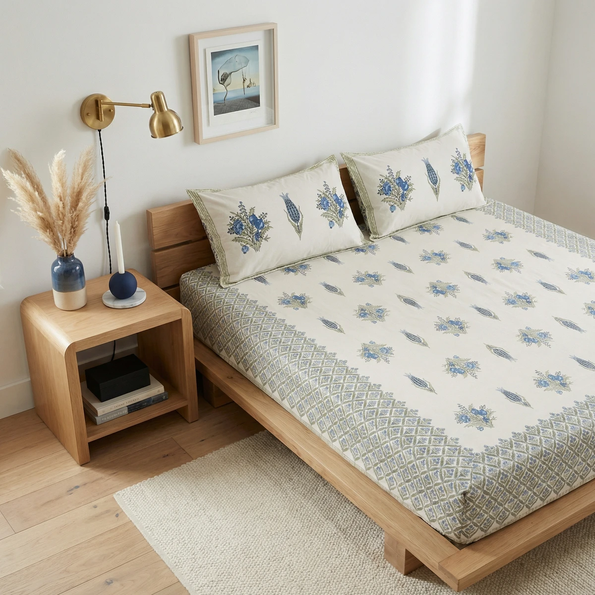 Kanika bed sheets featuring a blue and green floral block print pattern on an off-white cotton fabric.