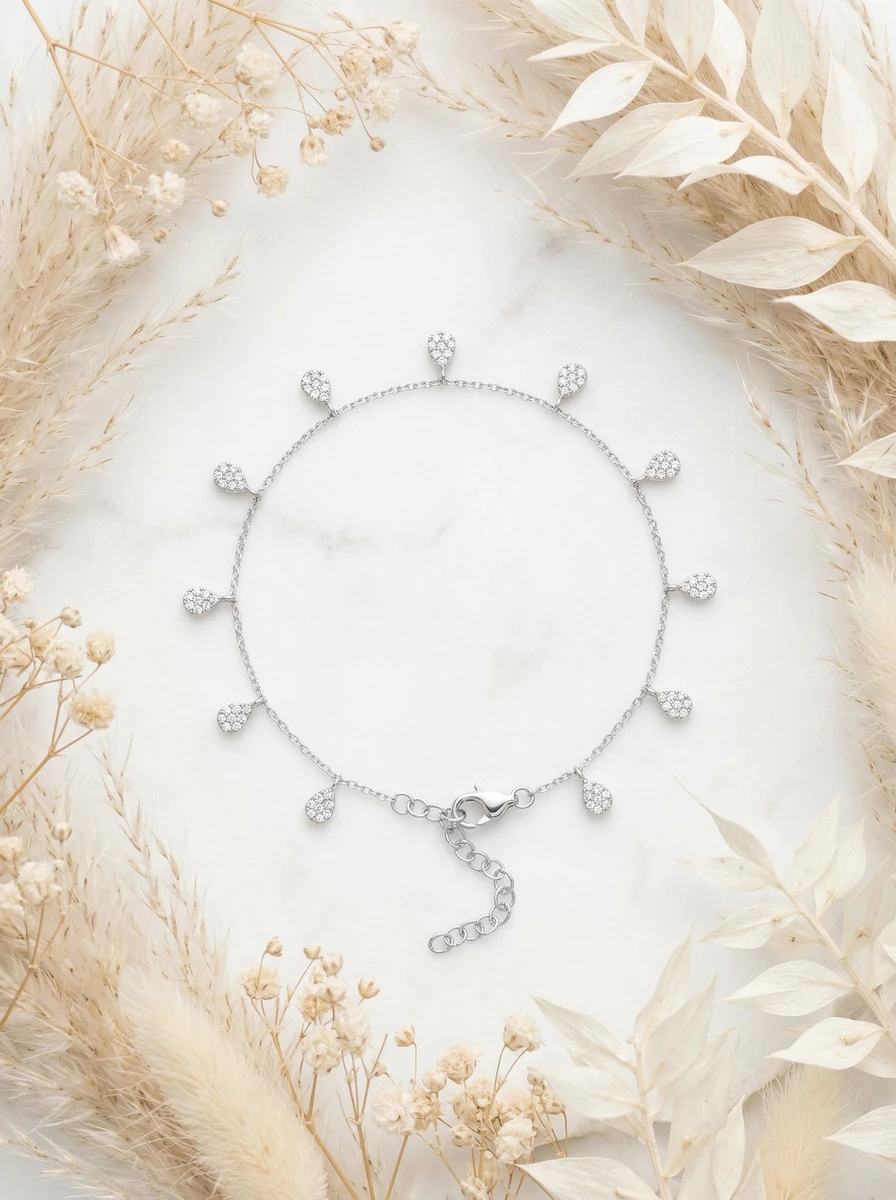 AI flat-lay photoshoot of a silver charm bracelet with teardrop charms, for a bracelet brand selling on marketplaces
