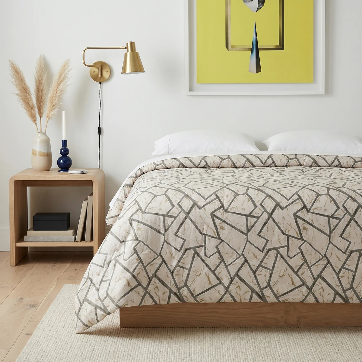 Kanika comforter with geometric pattern displayed on a bed in a minimalist bedroom setting