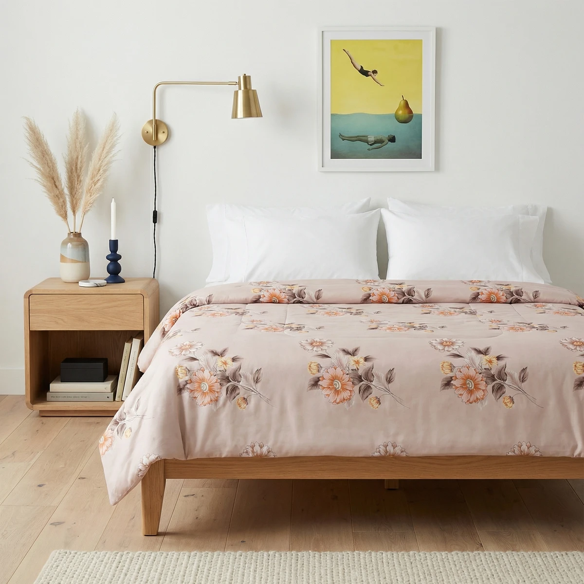 Kanika comforter with muted pink floral pattern on a wooden bed frame in a light, minimalist bedroom setting.
