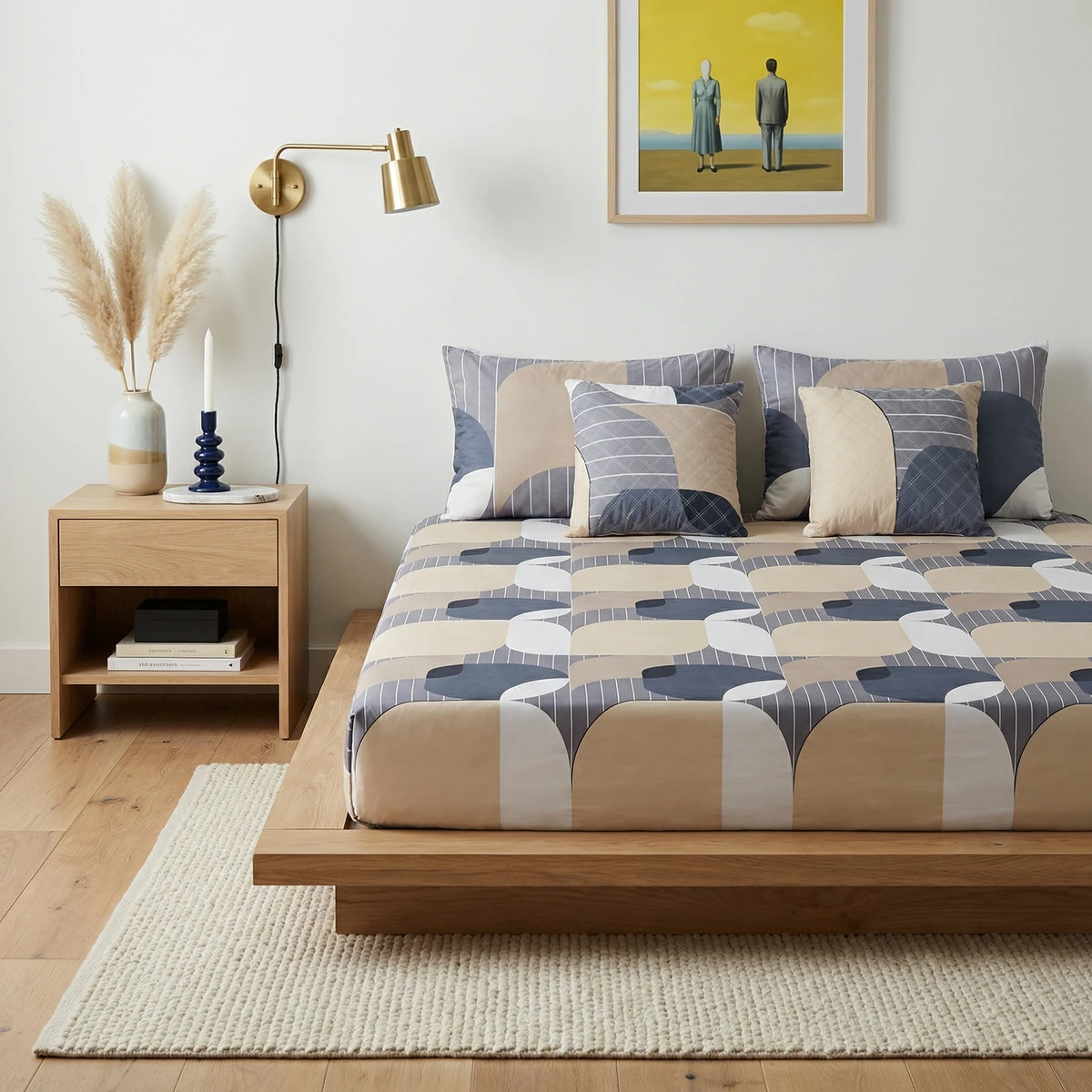 Kanika bed featuring geometric patterned bed sheets in blue, beige, and white tones with matching pillows in a modern bedroom.